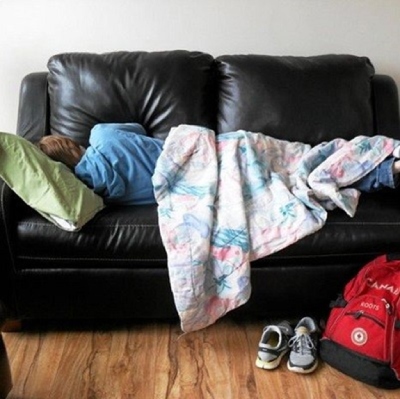 Homeless person sleeping on sofa